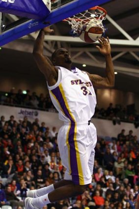 Great start ... Taj McCullough dunks during the Sydney Kings' upset 84-68 win last night over the Melbourne Tigers to open the new NBL season.