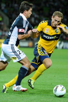 Harry Kewell taking on Rostyn Griffiths during his time at Central Coast.