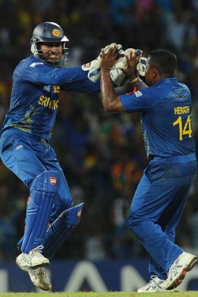 Out: Sri Lanka's Kumar Sangakkara and Rangana Herath celebrate a wicket in their World Twenty20 semi-final.