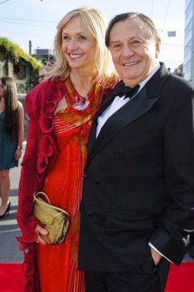 Cast member Barry Humphries and his wife Lizzie Spender pose on the red carpet.