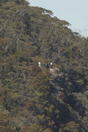 NSW police officers look out over the clifftop near Sublime Point, Leura.