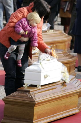 A tiny victim's white coffin.