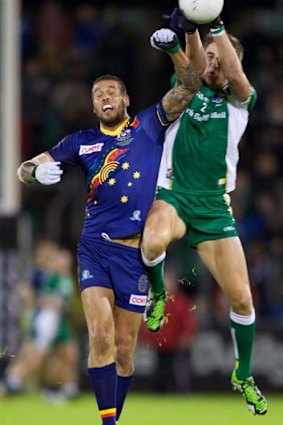 Lance Franklin grapples with Aidan Walsh.