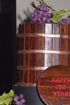 A basket press-style cake marks the century milestone.