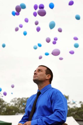 James Wright, Bridget's dad, looks on as the community release the balloons in memory of his little girl.