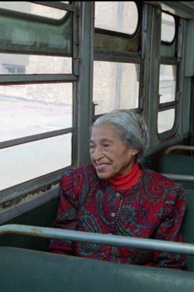 Civil rights pioneer Rosa Parks sits in a 1950s-era bus in Montgomery, Alabama in 1995.