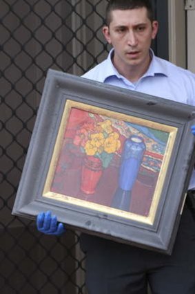 Rare discovery: A painting is removed from the Wiley Park house.