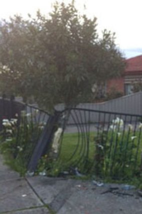 The fence after a car crashed into it this morning.