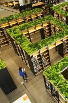  Green theme: The Naver library's bookshelves are laid out like a maze and topped  with hydroponic plants.