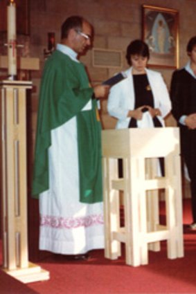 Father Victor Rubeo officiating at the baptism of Mr Hersbach's youngest daughter in 1983.