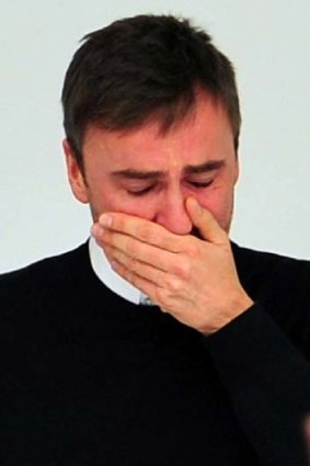 Belgian designer Raf Simons cries at the end of his final Jil Sanders show.