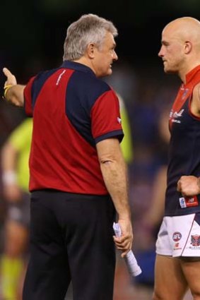 Neil Craig has a word of advice for Nathan Jones during the match against the Western Bulldogs.