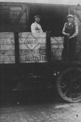 Coming to Canberra: The boxes containing the lions are loaded on a train by Ypres workmen Remi Loison and Theo Tanghe in August 1936.