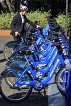 A rider at the Melbourne Bike Share scheme station at Melbourne University.