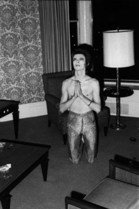 David Bowie in his hotel room before a performance at the Auditorium Theatre, Chicago, October 7, 1972. ''He was always a very playful personality and this spoof praying gesture was a typical moment,'' says Rock. 'Note the cigarette in his left hand.'