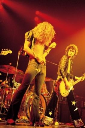 Jimmy Page on guitar and Robert Plant on vocals perform in Led Zeppelin during filming in 1973 of <i>The Song Remains The Same</i>.