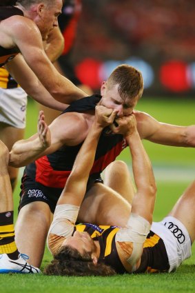 Hawthorn's Ty Vickery gives Essendon's Shaun McKernan a jumper punch, in the round one clash this year.