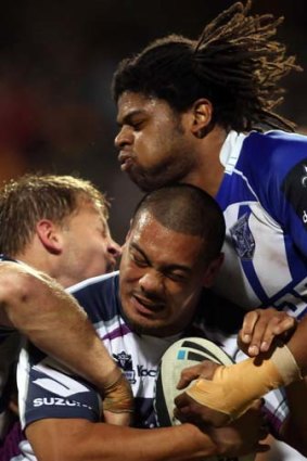 Attack Dogs ... David Stagg and Jamal Idris pounce on Melbourne's Sika Manu last night.