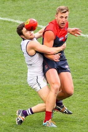 Hayden Ballantyne tackles Lynden Dunn of the Demons during round 21.