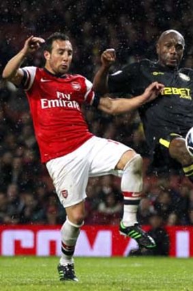 In step: Santi Cazorla (left) and Emmerson Boyce vie for the ball.