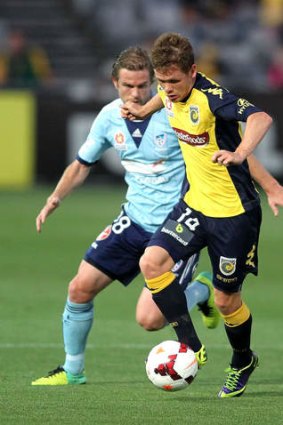 Michael McGlinchey of the Mariners gets away from Matthew Thompson of Sydney FC.