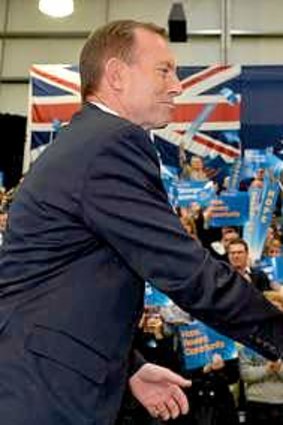 Hero: Tony Abbott and former PM John Howard shake hands.