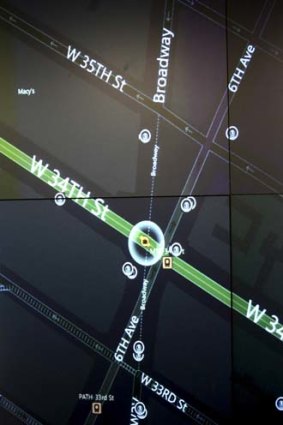 A video wall shows New York police officers an interactive map of an area in the city.