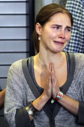 Amanda Knox cries and gestures to friends after arriving back in Seattle following her release from prison in October 2011.