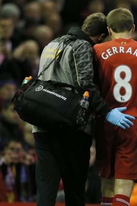 Liverpool's Steven Gerrard talks to a member of the club's medical staff.