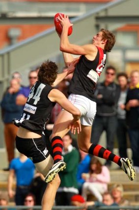 Joe Daniher leaps to take a mark ahead of Collingwood's Corey Gault in the VFL.