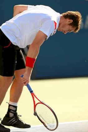 Frustrated: Murray smashes his racquet after losing the first set.