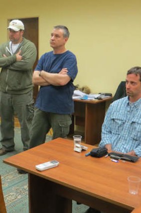A man claimed by the FSB to be Ryan Fogle, right, a third secretary at the US Embassy in Moscow, with Embassy officials at left, sits in the FSB offices in Moscow.