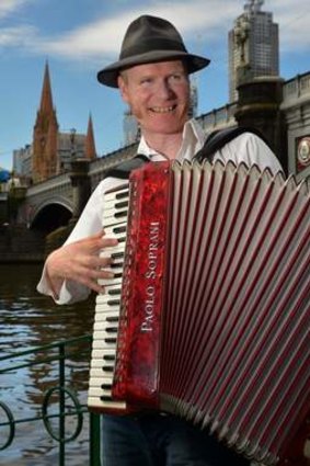 Dave Evans playing accordion near the Yarra.