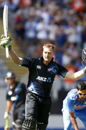 Martin Guptill acknowledges the applause after reaching his century.