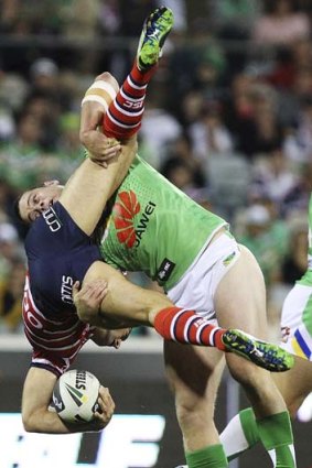 Down to earth: Anthony Minichiello is tackled by Shaun Fensom.
