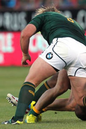 Dom Shipperley is tackled by South Africa's Tendai Mtawarira and Jannie du Plessis