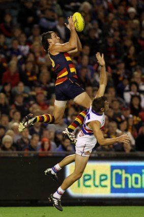 As the Crow flies: Forward Taylor Walker marks spectacularly over Bulldog Ryan Hargrave.