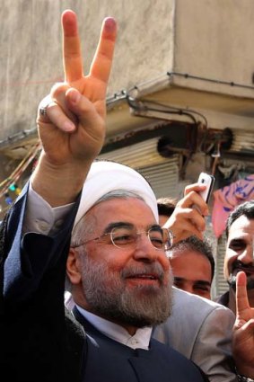 Popular: an optimistic Hassan Rohani outside a polling station.