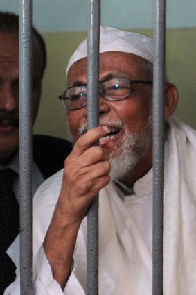 Radical Indonesian cleric Abu Bakar Bashir is seen in a court detention cell during his verdict at a Jakarta court in 2011.
