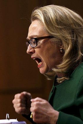 U.S. Secretary of State Hillary Clinton pounds her fists as she responds to intense questioning over the Benghazi attack.