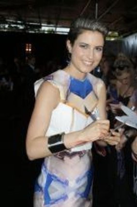 Missy Higgins signs autographs for fans in Sydney in 2012.