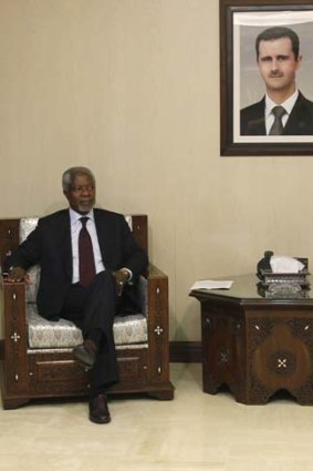 Hot seat &#8230; special envoy Kofi Annan sits in front of an image of Syrian President Bashar al-Assad before their meeting in Damascus.