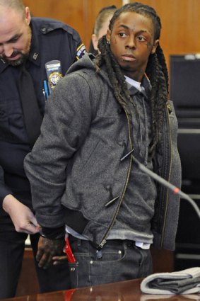 Rapper Lil Wayne is handcuffed at Manhattan criminal court after being sentenced.