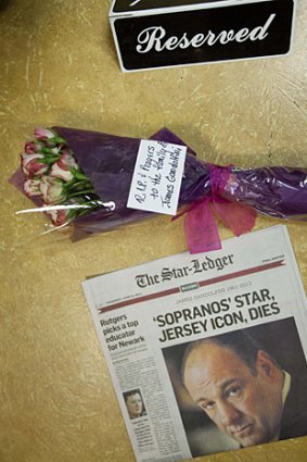 A newspaper and bouquet of flowers adorn a booth in Holsten's Ice Cream Shop, where the final scene of <i>The Sopranos</i> was filmed.