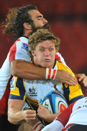 Big hit &#8230; Michael Hooper is tackled by Josh Strauss.