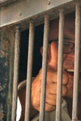 A still from the film <i>Dancing with Dictators</i> shows him in custody.