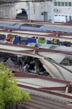 The mangled roof over a platform is seen at the site of a train accident at the railway station of Bretigny-sur-Orge, near Paris.