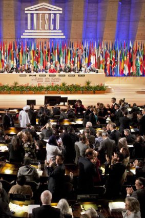 Delegates applaud after approving Palestine's membership of UNESCO at the agency's general conference in Paris.