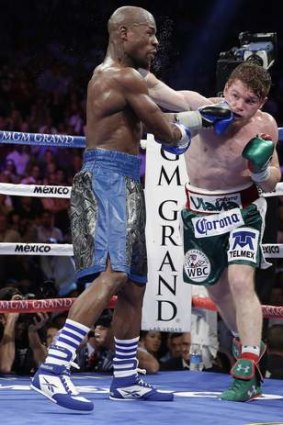 Floyd Mayweather Jr., left, exchanges punches with Canelo Alvarez in the seventh round.