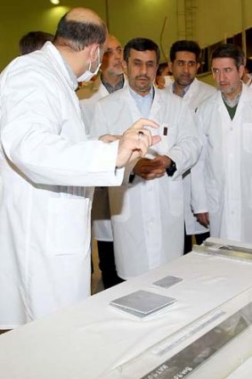 President Mahmoud Ahmadinejad listens to an expert during a tour of Tehran's research reactor.